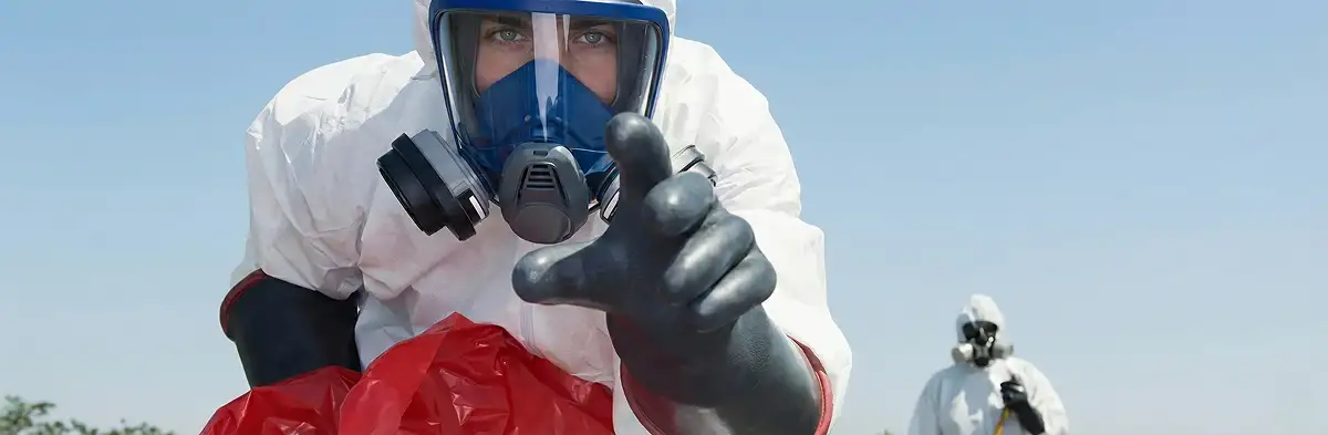 sewage clean up technician wearing protective gear handling biohazard materials in Lakeland, FL